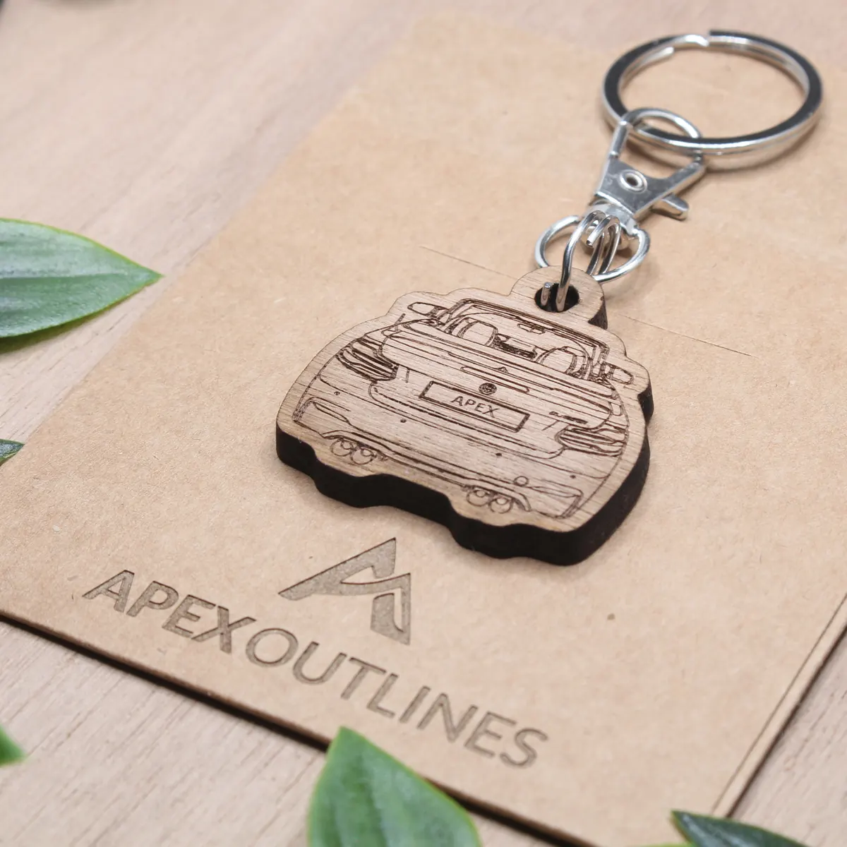 A finished walnut car keychain in the Apex Outlines workshop
