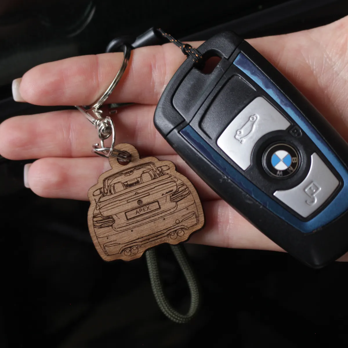 The engraved walnut keychain on a set of car keys